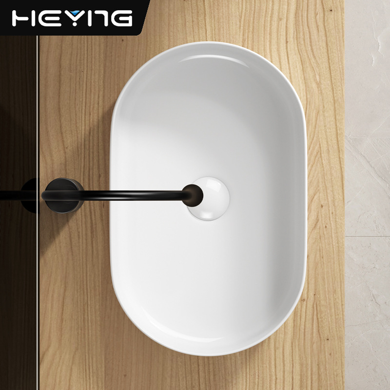 Minimalista lavabo de mesa elíptico arte cerámica lavabo de mesa hotel lavabo doméstico lavabo al por mayor