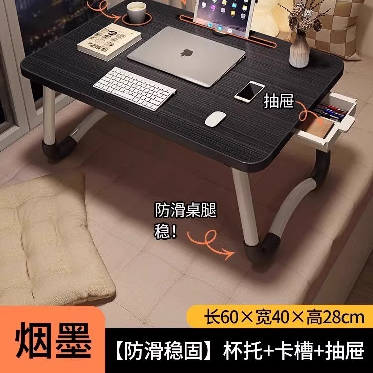 折り畳み可能なベッドの上の小さなテーブルは机のノートパソコンのテーブルを勉強します。|undefined