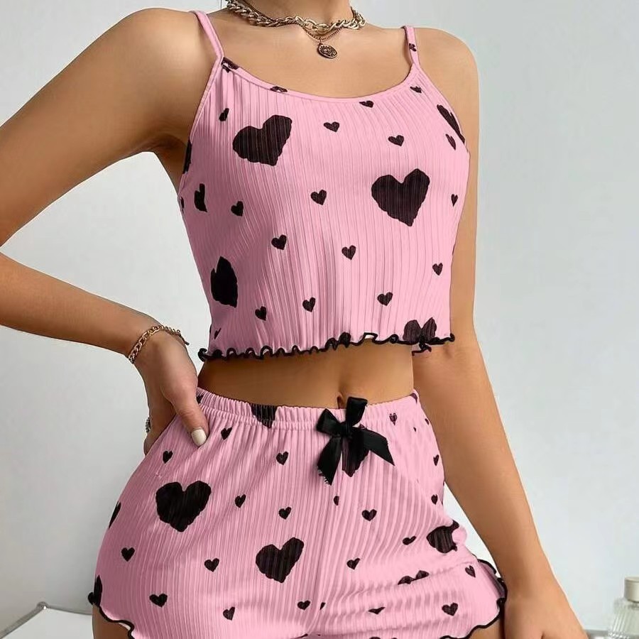 Ropa a domicilio para damas transfronterizas europeas y americanas de dos piezas con hilo estampado de hoyos amor tirantes bowknot pantalones cortos pijamas mujeres