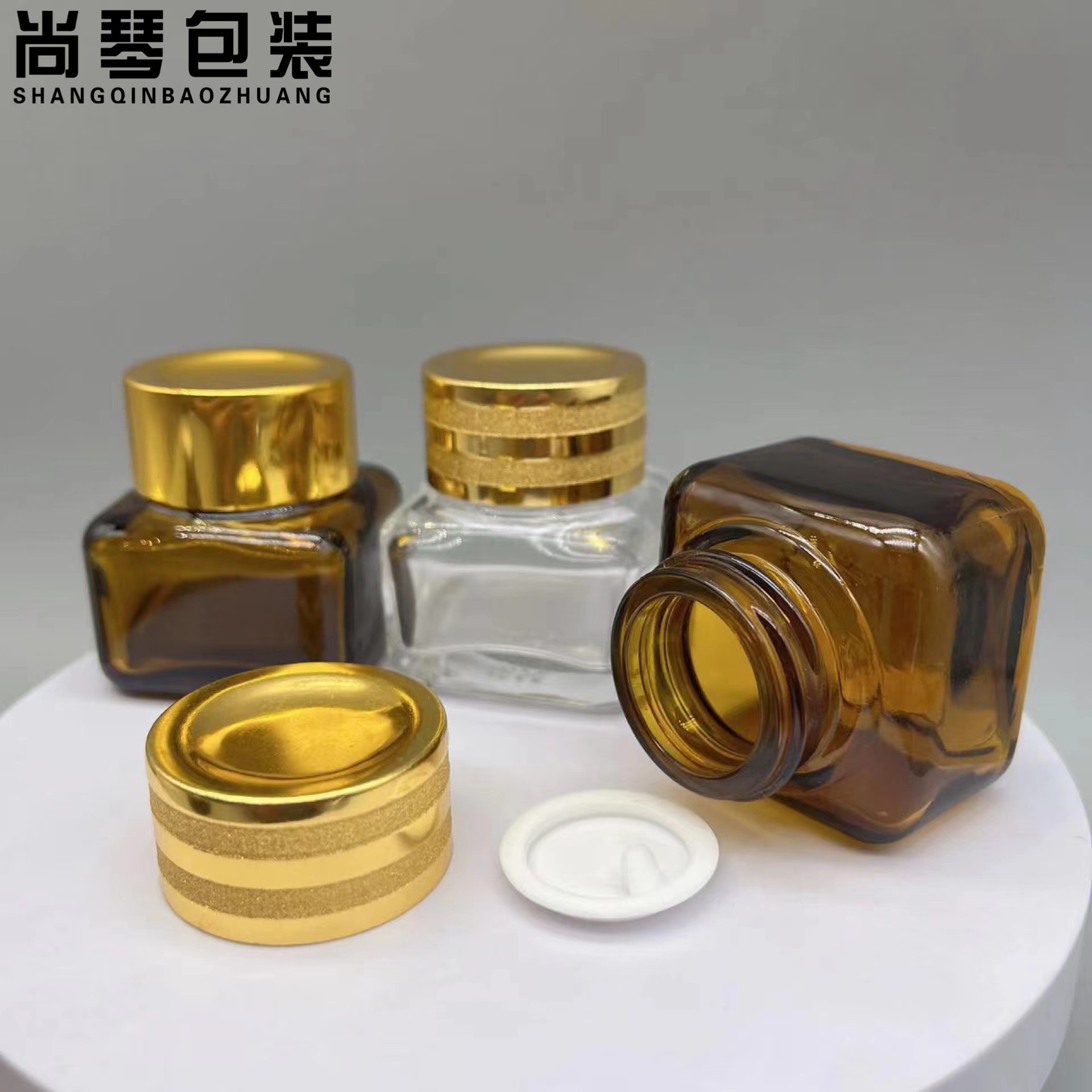 En stock suministro 15g Yashi mismo estilo marrón/transparente cuadrado ojo crema botella de vidrio de fondo grueso botella de vidrio cosméticos sub-embalaje