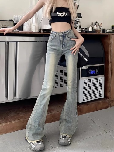 Slightly flared denim jeans for women: vintage autumn style, high waist, slimming fit, with a niche design and raw-edge hem.