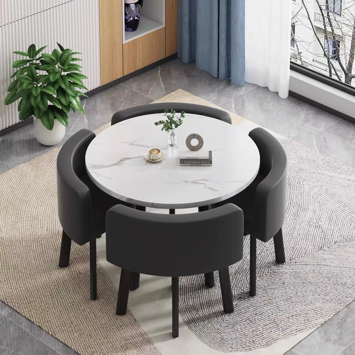 White round table + four black leather chairs