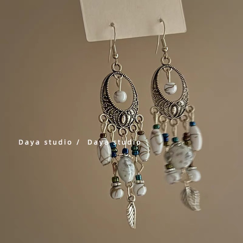 White ear clips with tassels