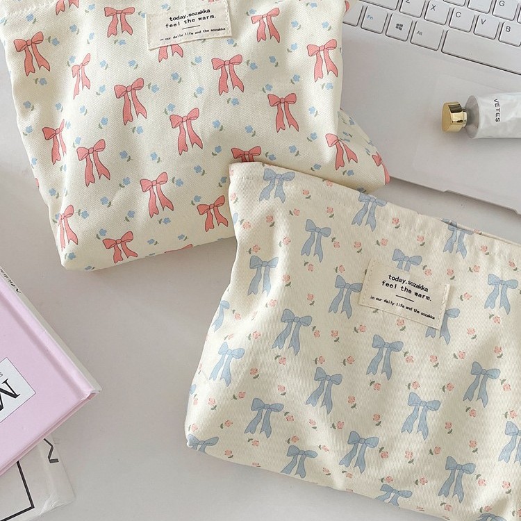 Cosmetic bag with bow, handheld storage system, cloth, wallet
