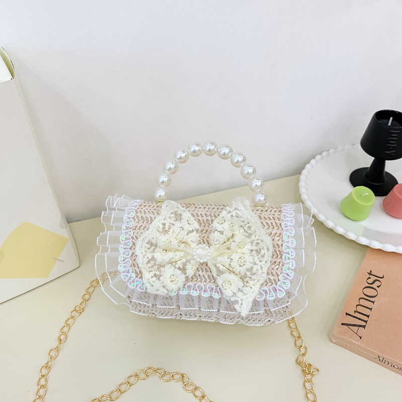 2025 verano nuevo arco de paja bolsa de perla portátil inclinada pequeña fragancia bolsa de moda para niños mochila para niñas