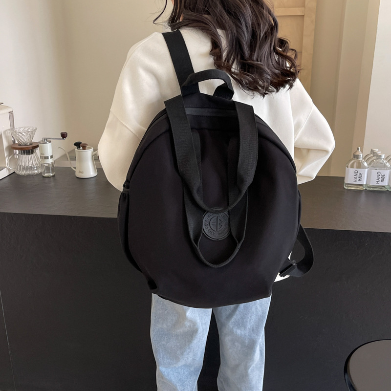 Small shoulder bag, one‑shoulder backpack style, round design, black