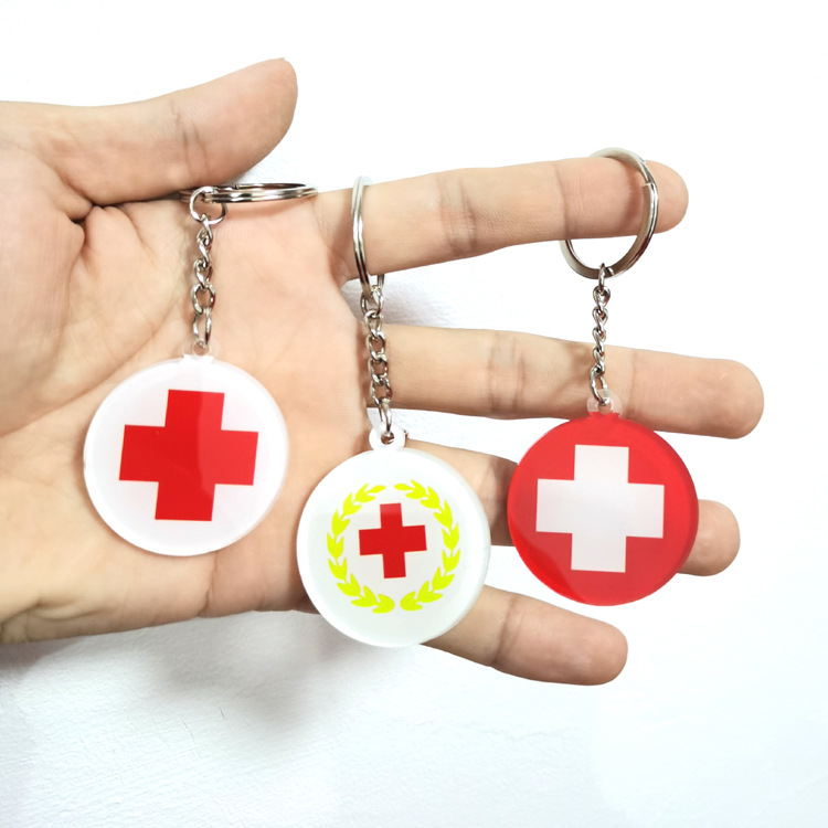 Company advertising and promotional items, volunteer group Red Cross keychains, and hospital charity event gifts.