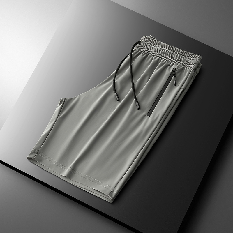 2025 nuevo verano más el tamaño de los pantalones deportivos de nailon pantalones de cinco puntos para hombres pantalones cortos de seda de hielo de color sólido de secado rápido fábrica al por mayor