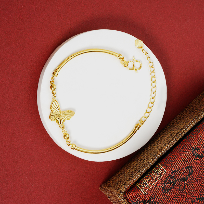 Simples y lujosos viento de oro de arena vietnamita mariposa pulsera de tubo de cobre de alta feminidad joyas de aleación de cobre en línea