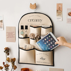 Fabric wall-mounted storage bag, hanging on the back of the door, wall-mounted item bag, dorm bed phone holder bag, magic bag