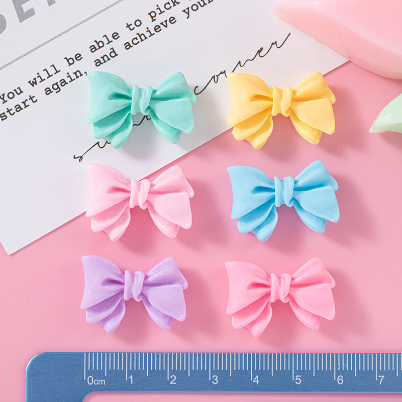 Accesorios de resina de arco de color macaron DIY Crema Accesorios de cuerda de cabello de agujero de caja de teléfono móvil Colgante de hebilla de zapato