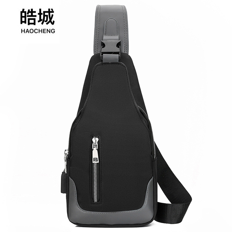 Comercio exterior nuevo bolso de pecho casual de color en contraste para hombres bolso de mensajero recargable USB de tela Oxford resistente al desgaste bolso de hombro al por mayor