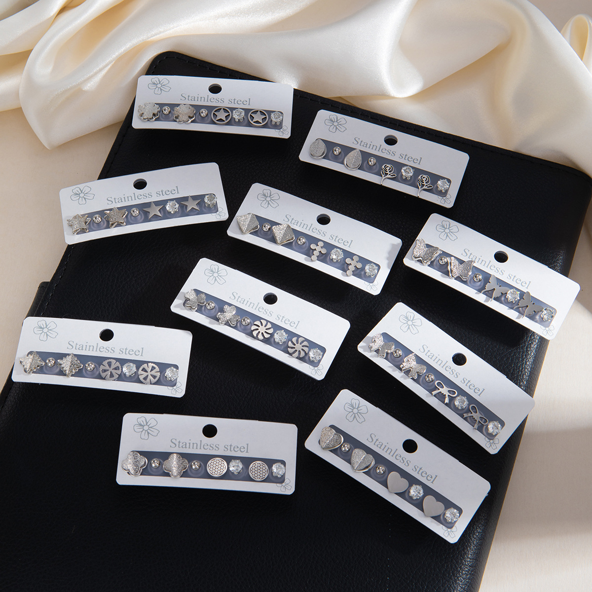 New European and American stainless steel earring set, simple floral earrings, fashionable light luxury niche cross earrings for women
