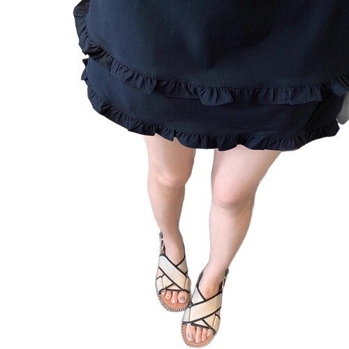 Retro black fungus edge short skirt for women, high-waisted splicing design, semi-slip A-line skirt with pleated lotus leaf edge, stylish casual attire.