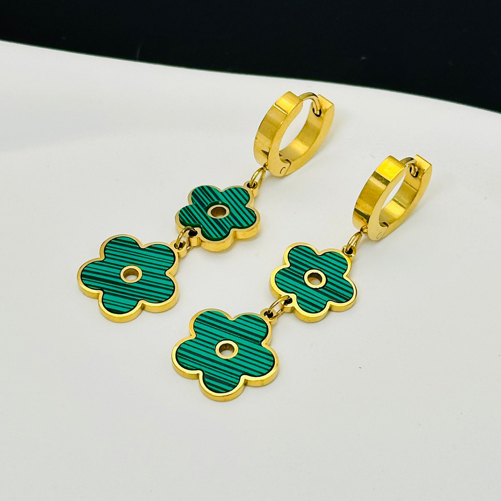 Creativo de cinco flores estilo retro europeo y americano temperamento versátil simple personalidad cuatro hojas colgantes aretes de joyas de acero