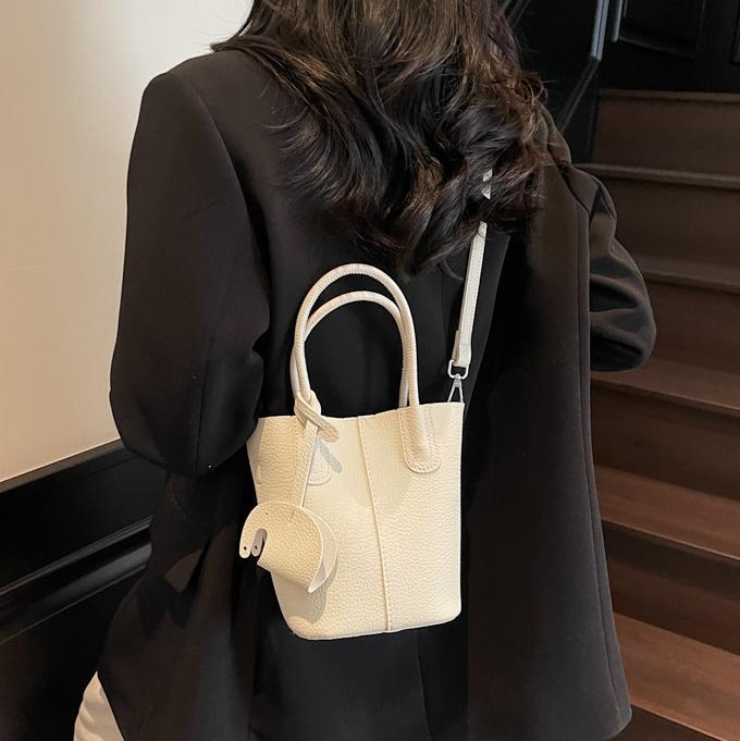 Bolso de cubo de venta caliente de comercio exterior, sentido de alta gama de nicho femenino 2025 nuevo bolso de mano simple y versátil, bolso de mensajero de moda y versátil