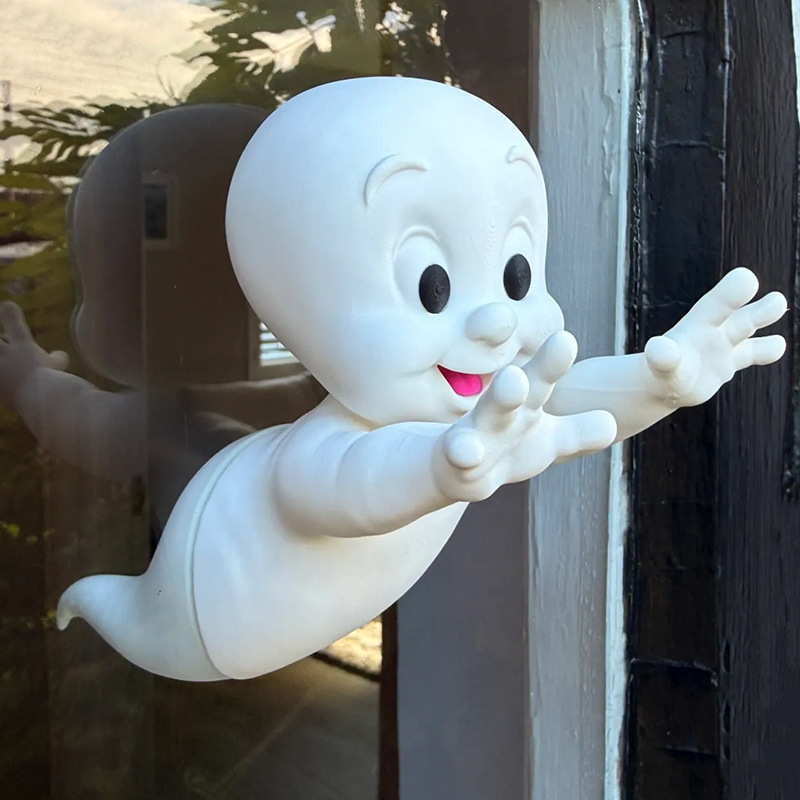 3D printed whimsical elf window sticker ornament, ghost passing through the window, festive atmosphere, magnetic glass decoration