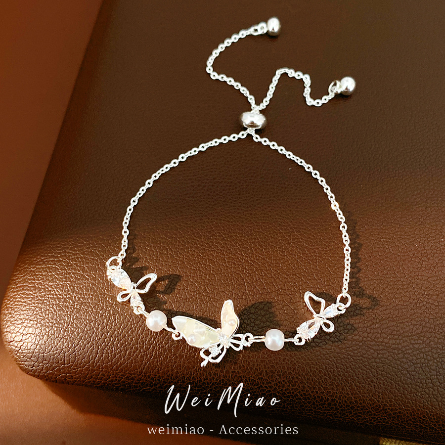 Pulsera de perlas de mariposa de marisco de marisco de piedra ligera de lujo de alto nivel de sensación de pulsera temperamento pequeño fresco y dulce joyería al por mayor