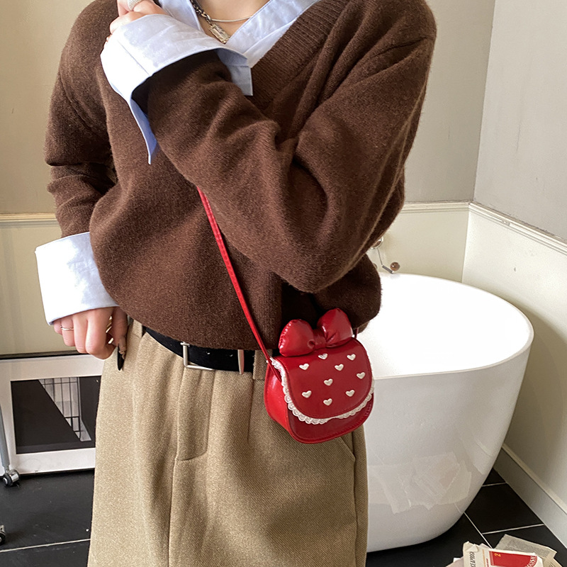 Coreana de alto valor para hombres y mujeres bolsos de hombro lindos arcos mini bolsos de cambio para bebés 2026 bolsos para niños amorosos