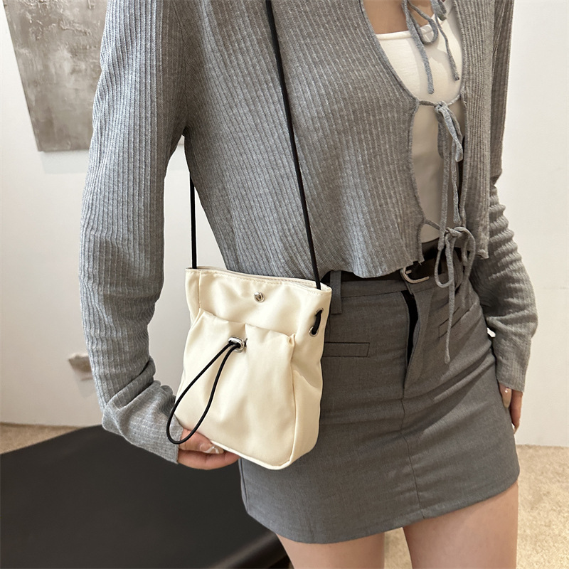 Bolsos de teléfono móvil de viento minimalistas para mujeres japonesas y coreanas bolsos de lona ligeros de cuerda de dibujo mini multifuncional bolsos de cambio de hombro