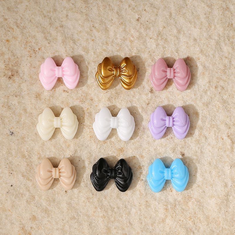 glossy golden three dimensional nail decoration with bow