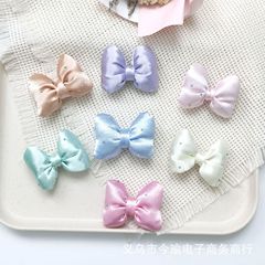 布芸のアイロン掛けの蝶結びの部品の明るい色の骨は髪飾りを結びます。