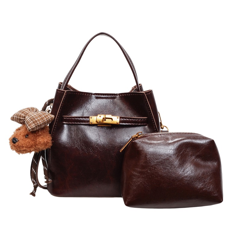 Otoño y invierno bolso de cubo de mano mujer 2025 nuevo estilo de alta calidad retro bolso de hombro universal de transporte público bolso de mujer