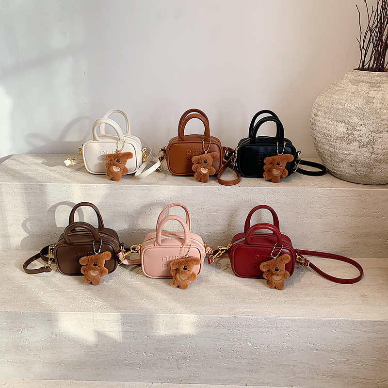 2025 nuevo bolso infantil coreano simple color sólido letras extranjeras bolso bebé mini bolso de bolos para niños