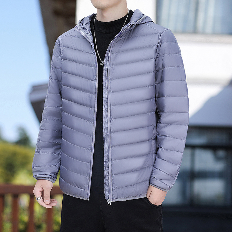 2023 Otoño e Invierno ligero abajo abrigo de algodón acolchado con capucha de los hombres regular más el tamaño abrigo de moda entrega de una sola pieza de los hombres