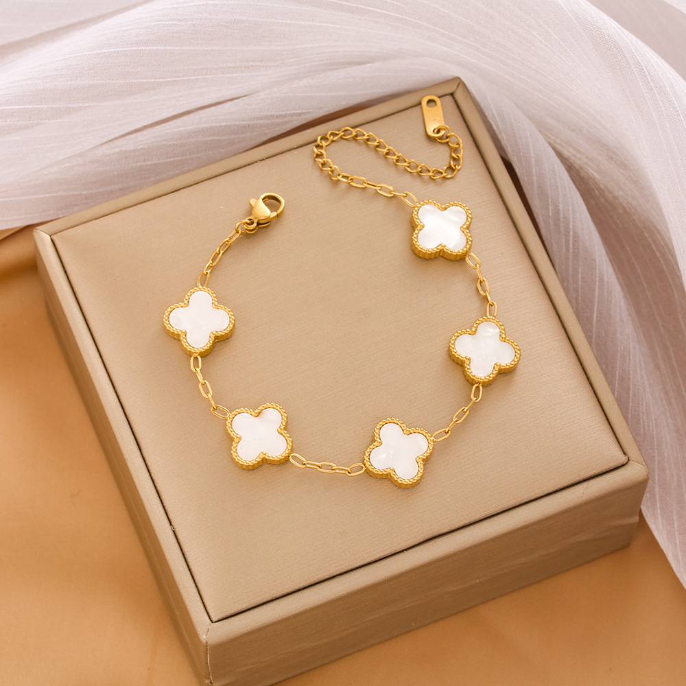 Pulsera de trébol de acero titanium vendedora caliente transfronteriza europea y americana con incrustaciones de concha pulsera colgante pulsera de diseño avanzado sin desvanecimiento al por mayor