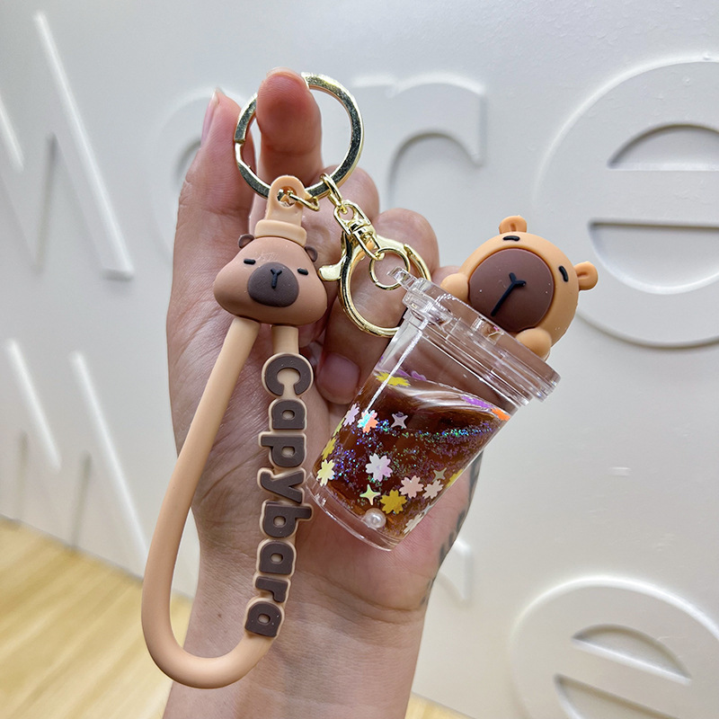 Botella creativa de aceite flotante Capibara Dolphin Keychain bolsos de automóviles exquisitos colgantes de arena flotante regalos al por mayor