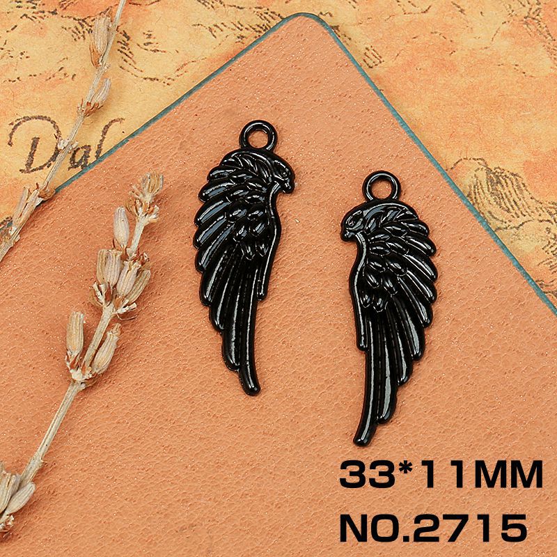 Aleación máscara cráneo electroforesis negro accesorios material al por mayor DIY colgante joyería Cruz alas negro colgante