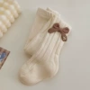 Beige tights with bow, with embroidery