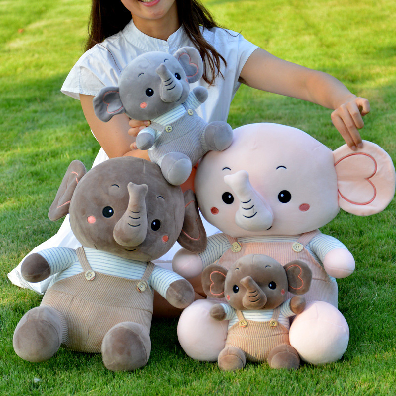 Caricatura muñeca elefante muñeca muñeca de peluche muñeca elefante muñeca niños calmar muñeca almohada en la cama