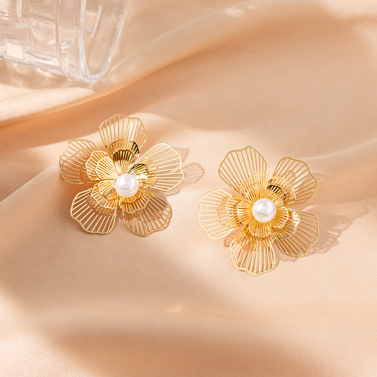 Pendientes de mariposa huecos dorados de alta gama Pendientes de perlas de diseño de nicho de estilo ins femenino Pendientes exagerados al por mayor