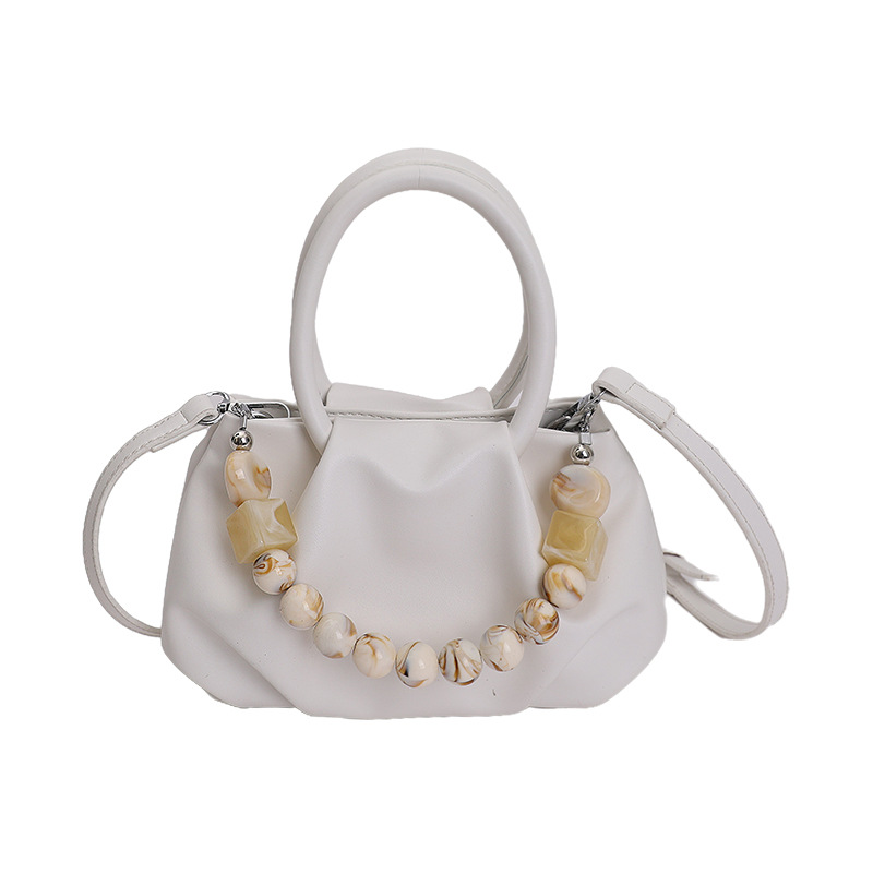 Alta sensación de mano pliegueada nube bolso de cubo para mujeres 2026 nuevo nicho de lujo ligero de moda perla bolsa de mochila
