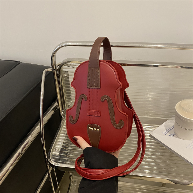Hermosa y extraña mochila de hombro para mujeres 2024 nuevo estilo de moda bolso de hombro portátil de red bolso de violín rojo