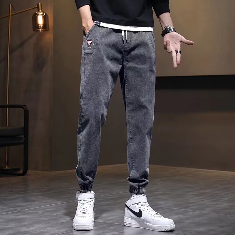 Otoño marca de moda Harlan jeans pantalones de pies pequeños de estilo coreano para hombres pantalones elásticos sueltos de otoño e invierno con cintura elástica para hombres