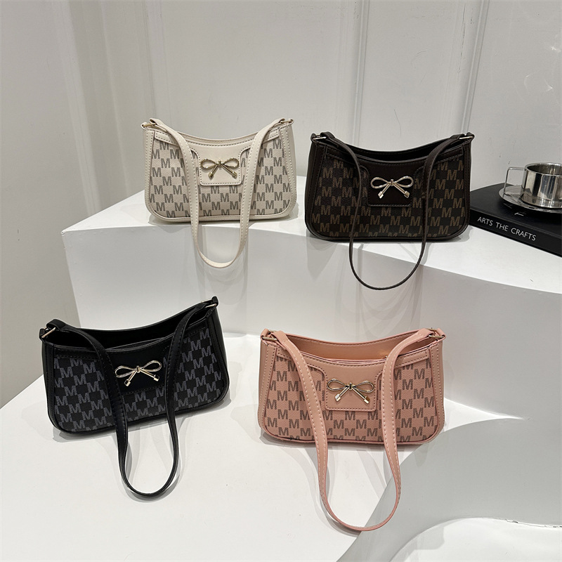 Cosmetía coreana estilo de moda textura arco de moda primavera 2025 nuevo estilo extranjero de viaje brazo bolso de hombro para mujeres