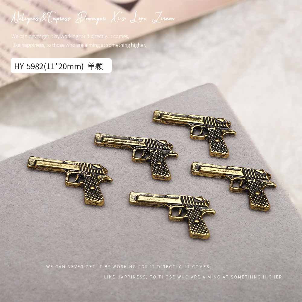 Europa y los Estados Unidos en línea con diamantes AK armas de manicuría joyas de simulación de personalidad tridimensional armas de fuego decoración de uñas al por mayor