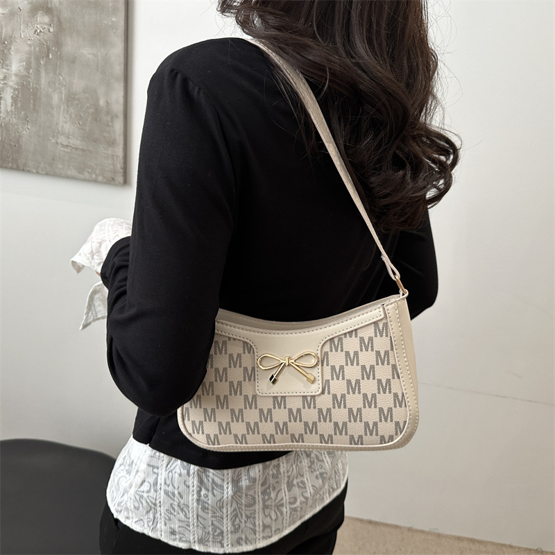 Tendencia universal bolso de hombro para mujeres 2025 nuevo estilo simple bolso de brazo de viaje de moda arco bolso de mano