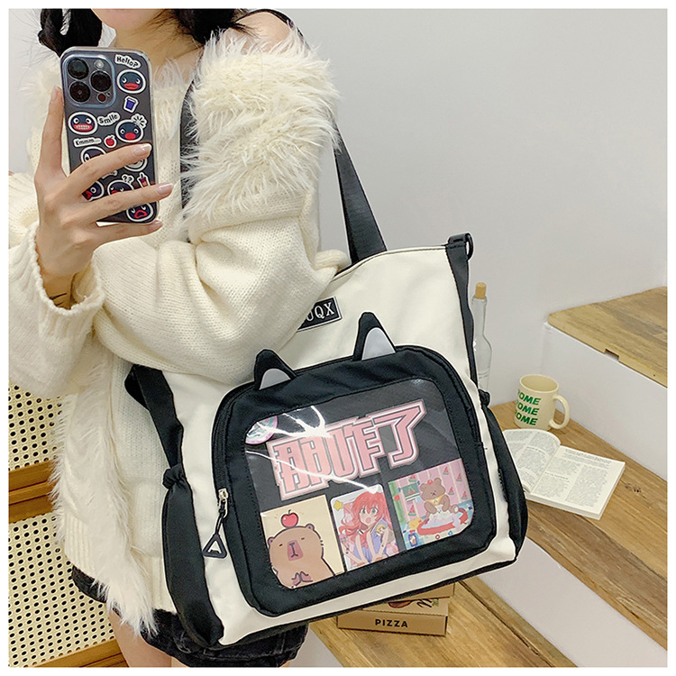 The new cute cartoon printed student bag with a large capacity and transparent student storage single-shoulder bag is selling well for women undefined
