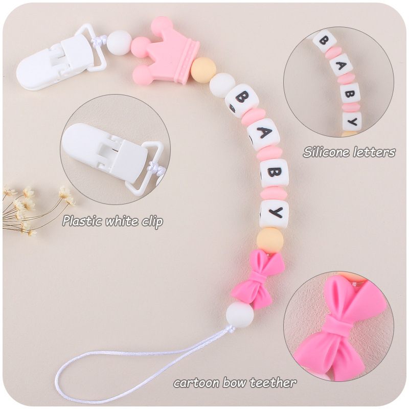 Suministros de bebé corona de dibujos animados cadena anti-gota bebé creativo DIY silicona mordedura pegamento molar chupete cadena