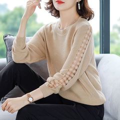 レースの底のニットの女性2025春秋の新型の韓国版のゆったりしている丸首の透かし彫りの上着のセーターの婦人服をつなぎ合わせます。