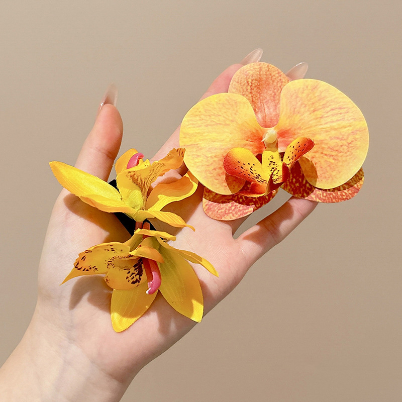 Atmosfera orquídea mariposa flores clip para el cabello mujeres primavera / verano 2025 nuevo clip lateral tocado tarjeta de cabello vacaciones de mar