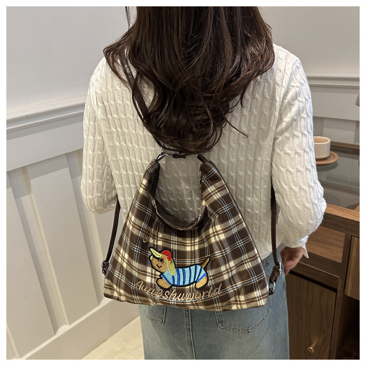 A new 2024 trendy and stylish backpack for women, featuring a cartoon checkered single-shoulder crossbody bag and a tote bag undefined