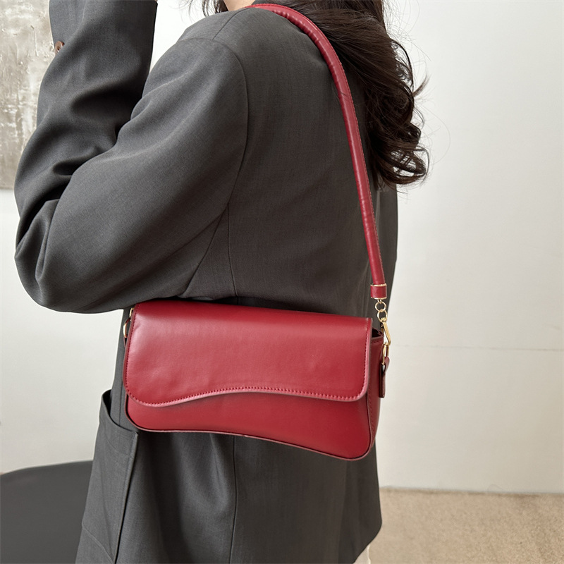 Bolso debajo de la axila para mujeres 2025 primavera nueva moda de alta sensación de hombro mochila de nicho bolso de textura cuadrada