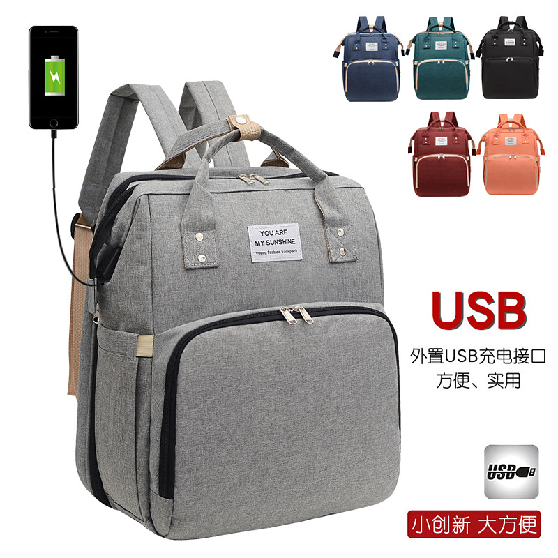 Mochila maternal multifuncional plegable con cuna y puerto USB, bolso de viaje de gran capacidad