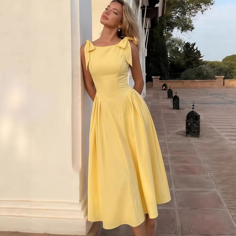 Yellow Dress with Bow Tie and Suspenders for Women, Featuring a Waist-Cinching Cut and a Flared Hem, Designed to Make Petite Individuals Look Taller