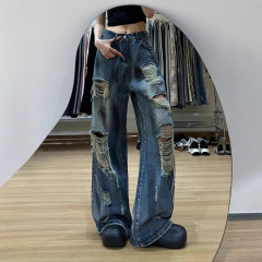 ヨーロッパとアメリカのハイストリートデザインの女性用リップドジーンズ、レイジースタイル、秋の薄いレトロな古い汚れた染めのフロアレングスパンツ